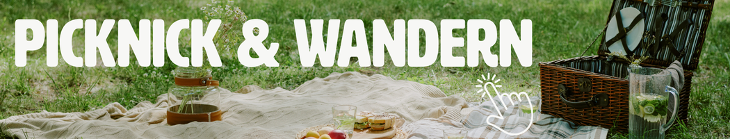 KI generiert: Ein Picknick auf einer Wiese mit einem geöffneten Korb. Text: "PICKNICK & WANDERN".