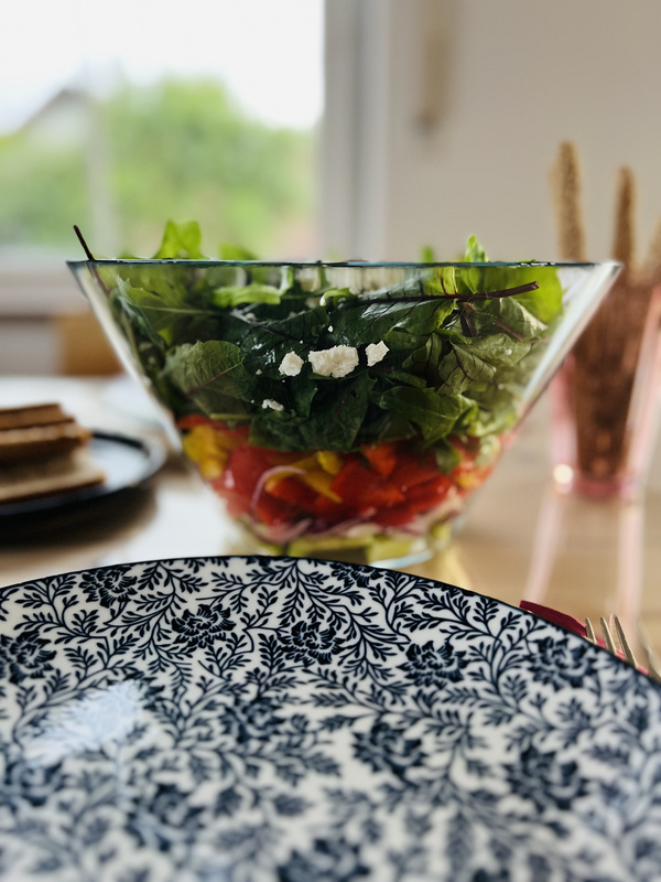 KI generiert: Eine Schale voller bunter Salat, im Vordergrund ein dekorativer Teller.
